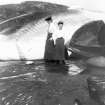 Two Edwardian ladies standing in front of a whale at the whaling station