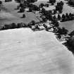 Oblique aerial view centred on farmsteading from E.