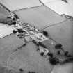 Oblique aerial view centred on church from SE.