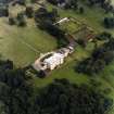 Oblique aerial view centred on the country house with walled garden adjacent, taken from the W.