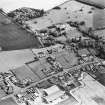 Oblique aerial view centred on the church, burial ground, walled garden and farmhouse, taken from the NNW.