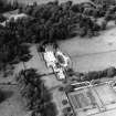 Oblique aerial view centred on the country house with walled garden adjacent, taken from the SSE.