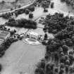 Oblique aerial view centred on the country house with walled garden adjacent, taken from the NE.