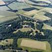 Oblique aerial view centred on the country house, with the farmsteading and the gate-lodge adjacent, taken from the SE.
