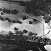 Oblique aerial view, taken from the SE, centred on the country house and the formal gardens.