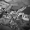 Oblique aerial view centred on village from N.