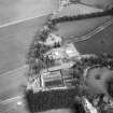 Oblique aerial view centred on country house from W.