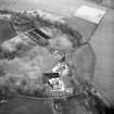 Oblique aerial view centred on country house from NW.