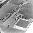 Oblique aerial view centred on the farmhouse and steading, taken from the SW