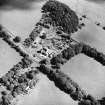 Oblique aerial view centred on the country house with the stables adjacent, taken from the W.