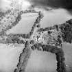 Oblique aerial view centred on the country house with the stables adjacent, taken from the SW.