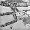 Oblique aerial view centred on the country house with the stables adjacent, taken from the SSE.