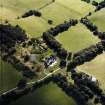 Oblique aerial view centred on the country house with the stables adjacent, taken from the N.