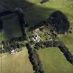 Oblique aerial view centred on the country house with the stables adjacent, taken from the WSW.