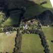 Oblique aerial view centred on the country house with the stables adjacent, taken from the SW.