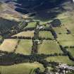 General oblique aerial view looking across the farmsteading towards the country house and stables, taken from the SW.