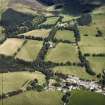 General oblique aerial view looking across the farmsteading towards the country house and stables, taken from the SW.