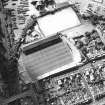 Oblique aerial view centred on the football stadium, taken from the ESE.