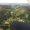 General oblique aerial view looking across Lochearnhead village and along Glen Ogle towards the Grampian mountains, taken from the SE.