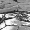 Balgray House and Lammonbie, oblique aerial view, taken from the ENE, centred on a cricket ground and lodge. Lammonbie farmsteading and cottages and a road bridge are visible in the centre top half of the photograph.