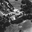 Oblique aerial view of country house from SE.