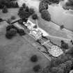 Oblique aerial view centred on country house from SE.