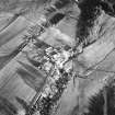 Oblique aerial view centred on the farmhouse and farmsteading, taken from the W
