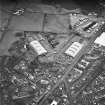 Oblique aerial view from NNW, centred on two L type hangars and the site of a third.