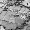 Oblique aerial view of New Abbey centred on the abbey with the abbey wall adjacent, taken from the N.