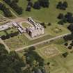 Oblique aerial view centred on the country house, garden, coach house and stables, taken  from the SW.