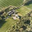 Oblique aerial view centred on the country house and stables, taken from the SSE.