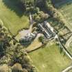 Oblique aerial view centred on the country house and stables, taken from the NE.