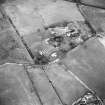 Ruthwell, oblique aerial view, taken from the SW, centred on the manse and the church and burial-ground.