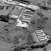 Oblique aerial view centred on Unit 2 of the explosves works and armament depot, showing the earthworks for burette houses and charge houses taken from the NW.  In the background is the S canteen and loading banks
Also visible is Edingham Industrial estate with Edingham farm poultry houses.