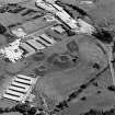 Oblique aerial view centred on Unit 2 of the explosives works and armament depot, showing the earthworks for the charge houses with in the background the S canteen and loading banks. taken from the NW.
Also visible is Edingham Castle, Edingham Industrial Estate with Edingham farm poultry houses.