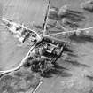 Oblique aerial view centred on the tower-house with farmsteading adjacent, taken from the SSE.