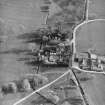 Oblique aerial view centred on the tower-house with farmsteading adjacent, taken from the NNE.