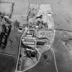 Oblique aerial view centred on the farmsteading with burial ground adjacent, taken from the SW