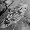 Oblique aerial view centred on the farmsteading with church and burial grounds adjacent, taken from the SSW