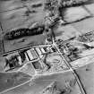 Oblique aerial view centred on the farmsteading with church and burial grounds adjacent, taken from the SSE