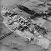 Oblique aerial view centred on the farmsteading with church and burial grounds adjacent, taken from the ESE