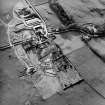 Oblique aerial view centred on the farmsteading with church and burial grounds adjacent, taken from the ENE

