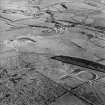 Oblique aerial view of Kirkcudbright training area centred on the tank track and field banks with firing position and Girdstingwood Headquarters adjacent, taken from the WSW.