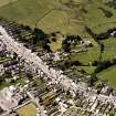 Oblique aerial view of Whithorn centred on the church, burial ground and the remains of the priory, taken from the ENE.