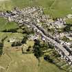 Oblique aerial view of Whithorn centred on the church, burial ground and the remains of the priory, taken from the WSW.