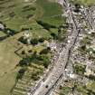 Oblique aerial view of Whithorn centred on the church, burial ground and the remains of the priory, taken from the SSW.