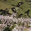 Oblique aerial view of Whithorn centred on the church, burial ground, manse and the remains of the priory, taken from the ESE.