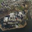 Oblique aerial view centred on the paper mill, taken from the SSE.