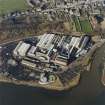 Oblique aerial view centred on the paper mill, taken from the SE.