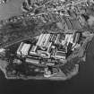 Oblique aerial view centred on the paper mill, taken from the SE.